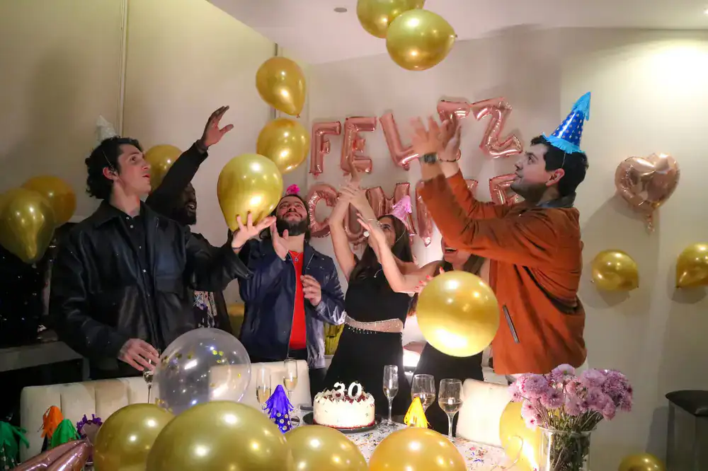 Friends cheering at a private birthday quiz event